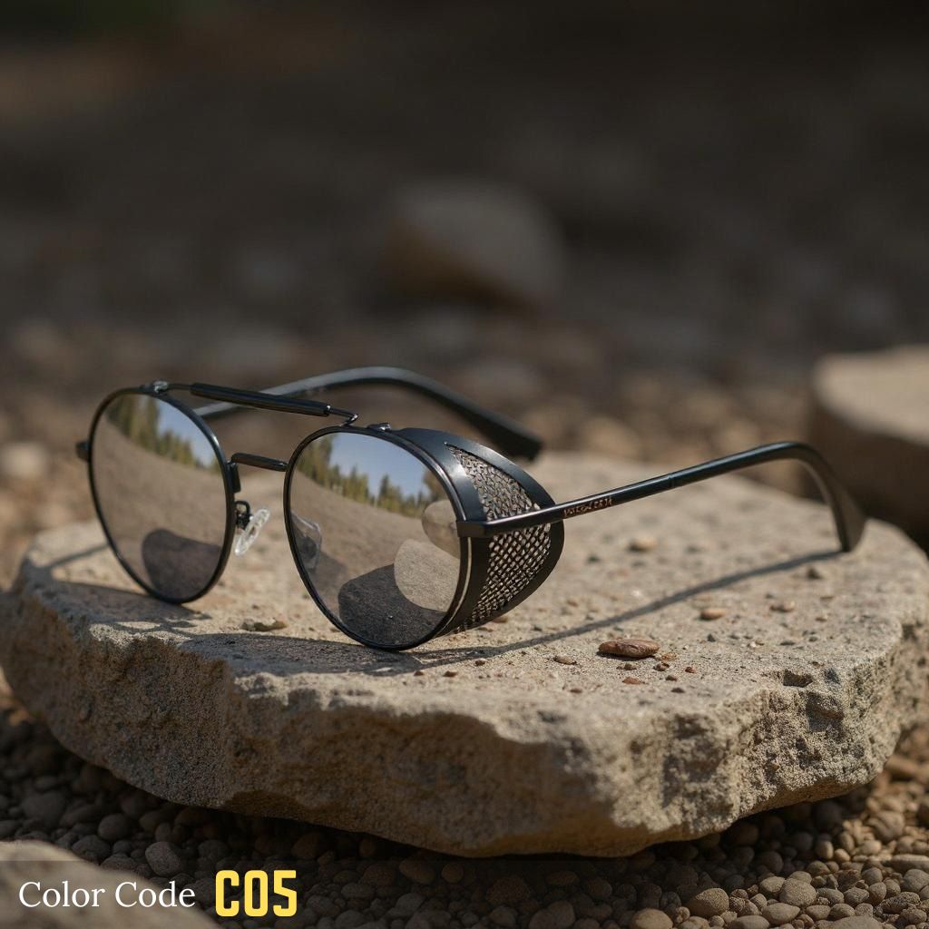 Sunglasses with metallic frame and dark lenses on a stone surface with a blurred natural background