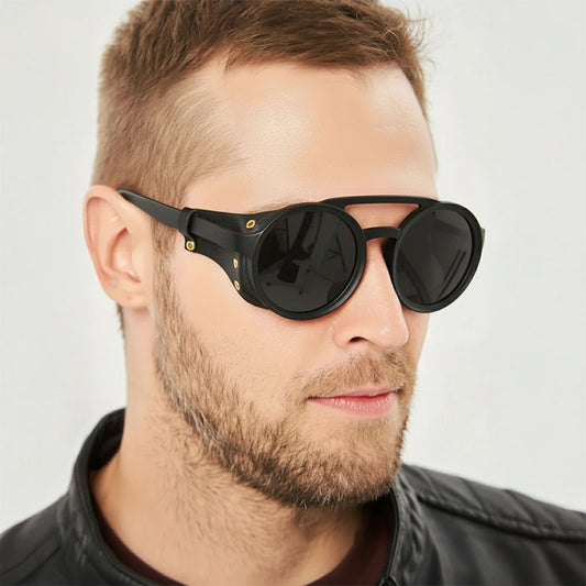 Man wearing black sunglasses with a neutral background