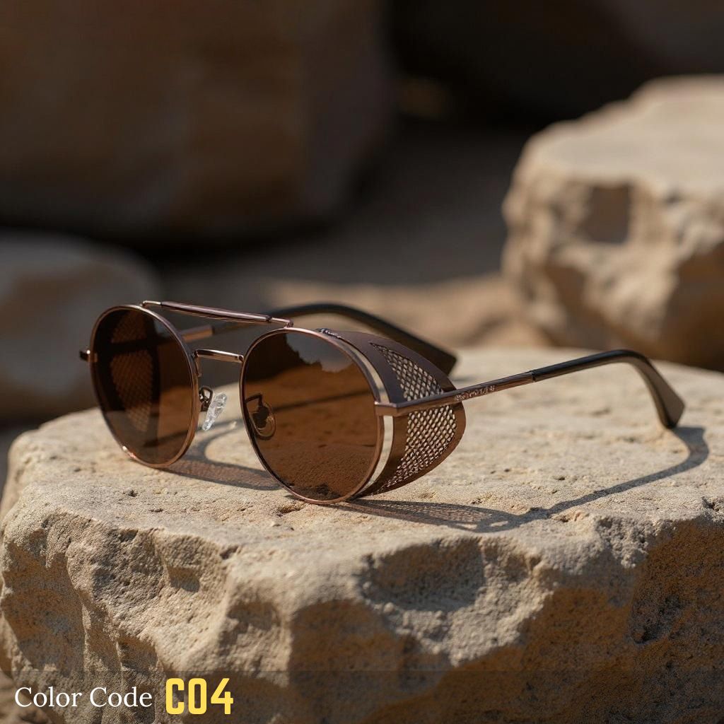 Sunglasses with brown lenses and gold frame on a rock with blurred natural background