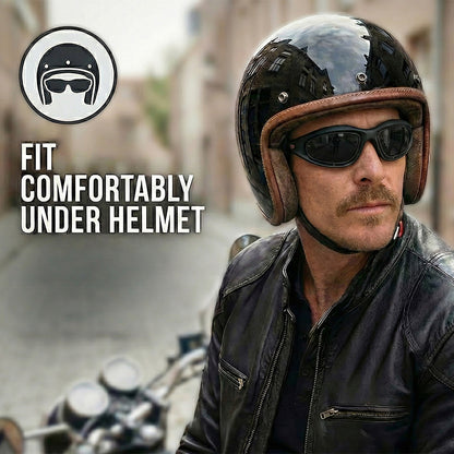 Man wearing polarized motorcycle sunglasses and a helmet with text 'Fit Comfortably Under Helmet' on a blurred street background.