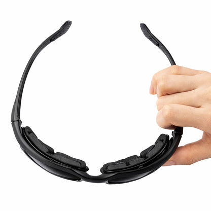 Black motorcycle sunglasses with soft sponge held by a hand on a white background